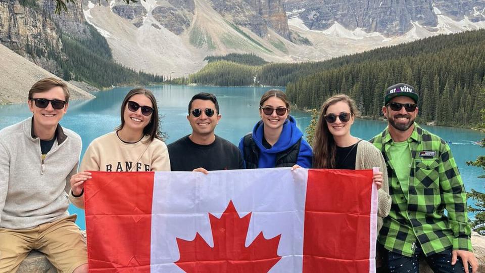 Students holding a Canada flag in front of Peyto Lake in the Rockies