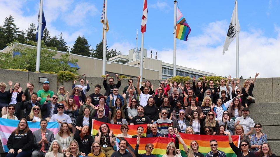 Group of people with Nanaimo Campus pride flag