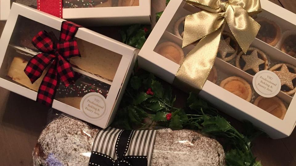 a variety of baked goods including a stollen, cookies, tarts