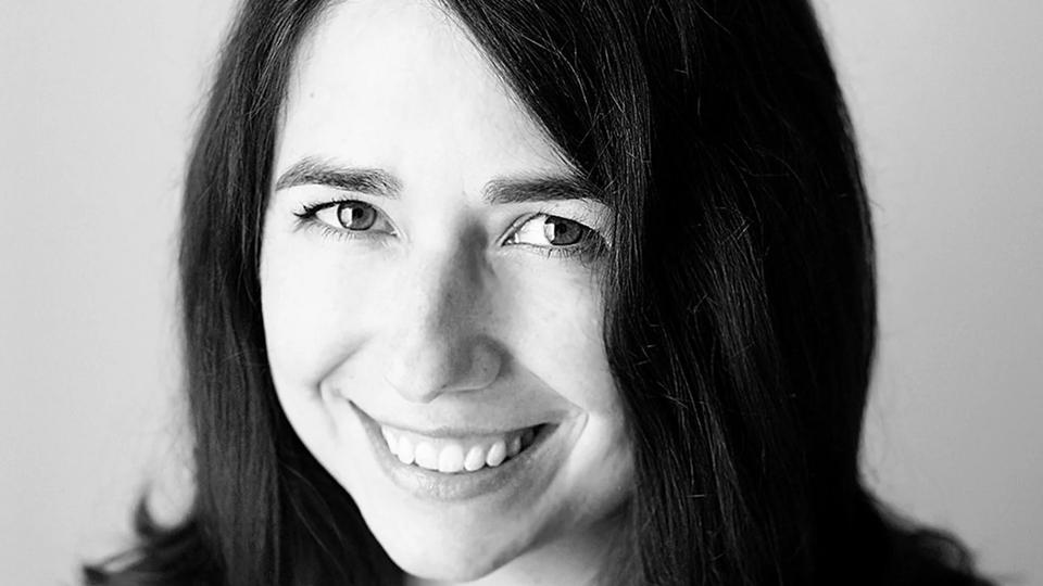 Black-and-white headshot of Rebecca Campbell, shoulder-length brunette hair
