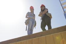 Women standing on roof in construction site